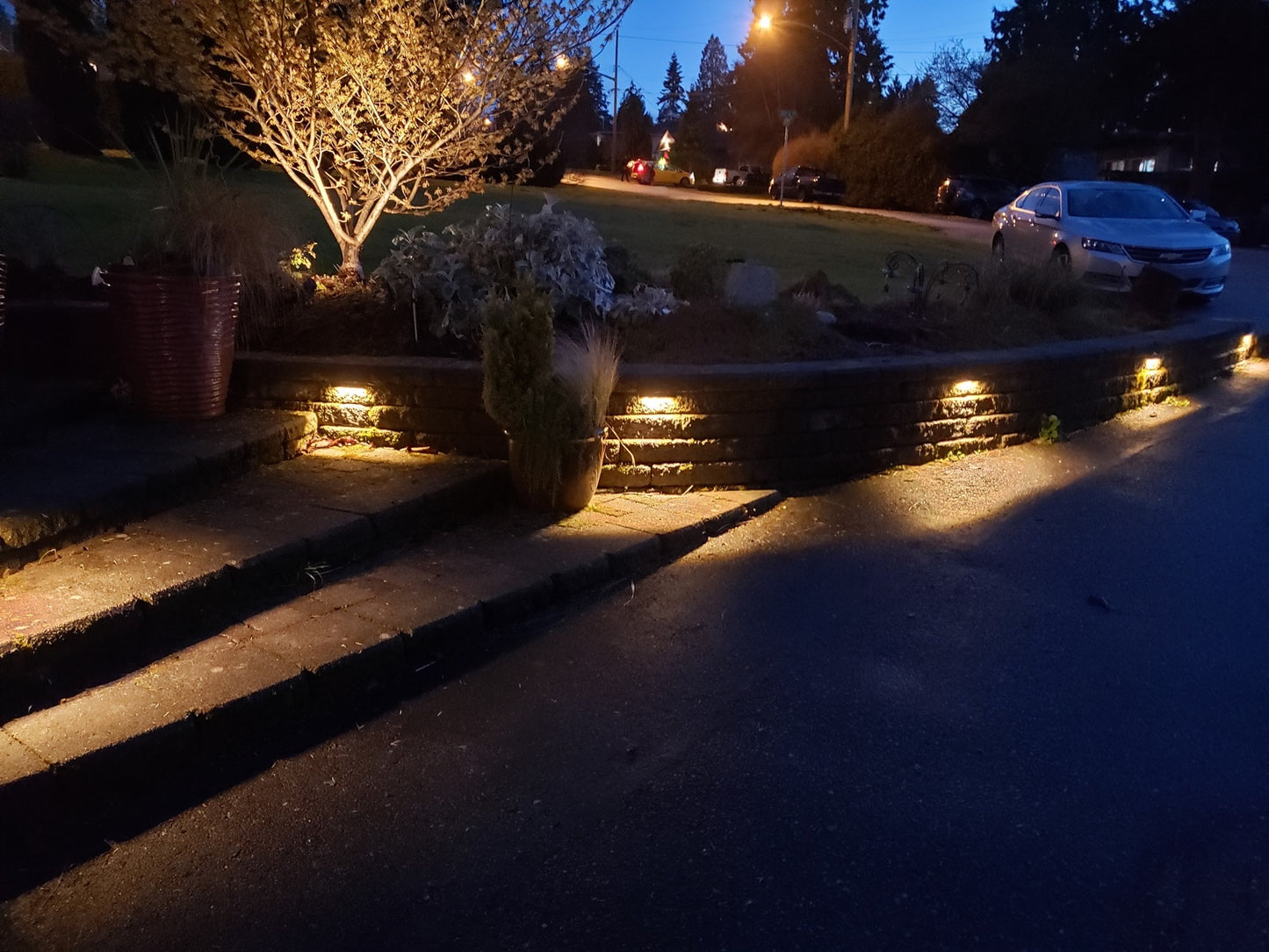 Brass LED Rail Light under a retaining wall at night